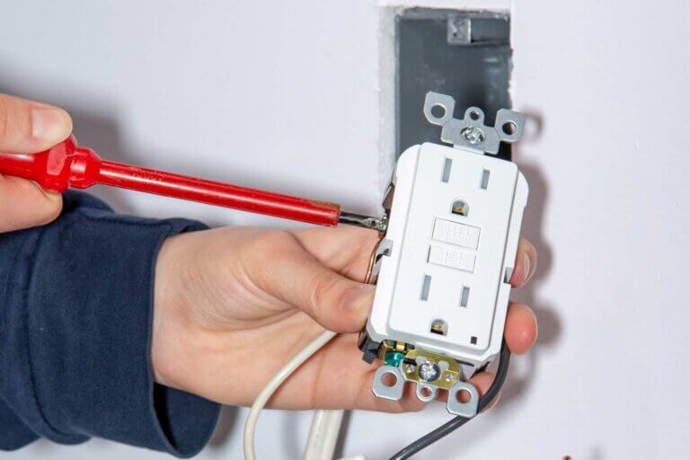 electrician installing gfci outlet